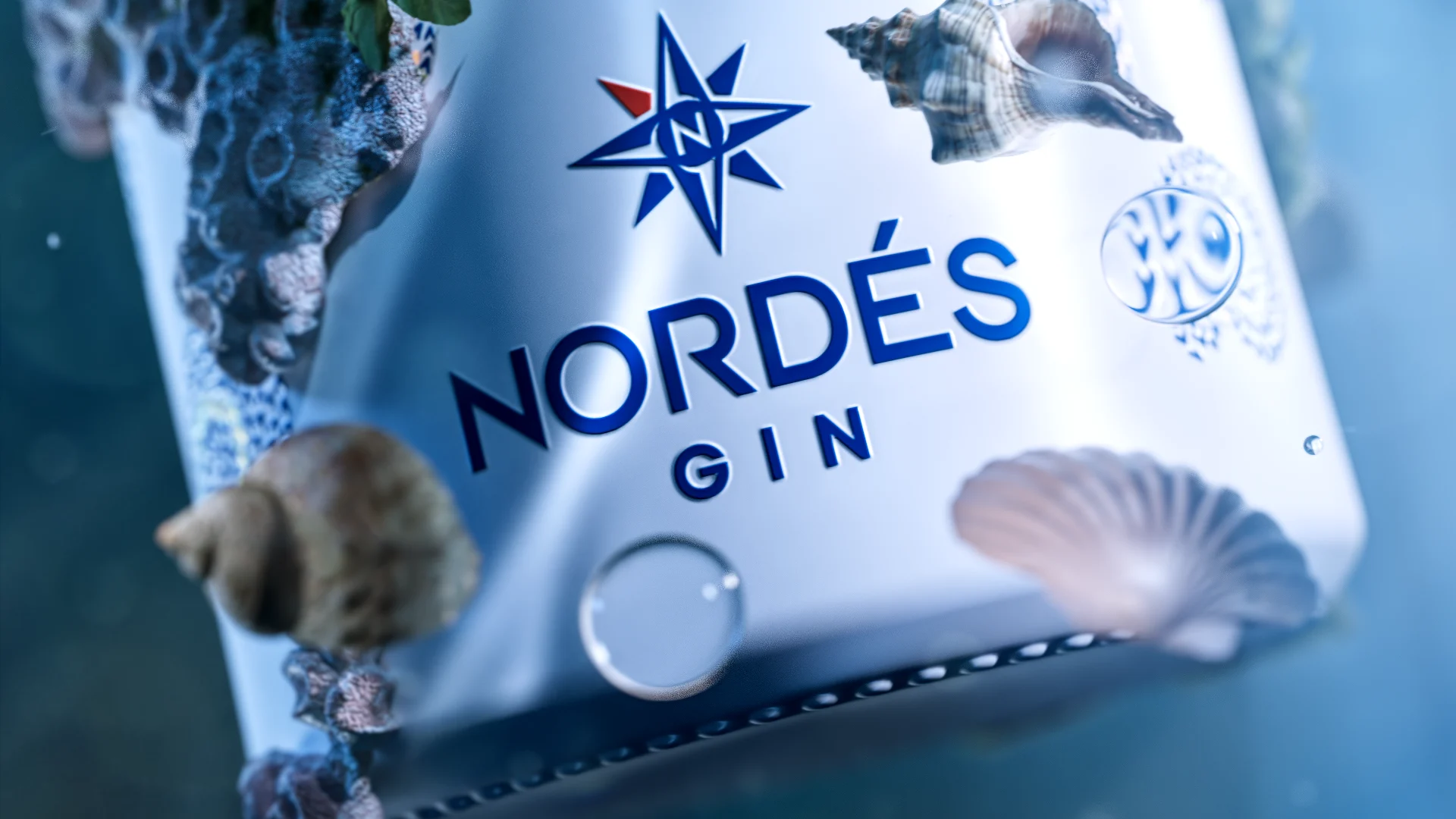 CGI Nordés Gin bottle surrounded by shells and sea-inspired elements